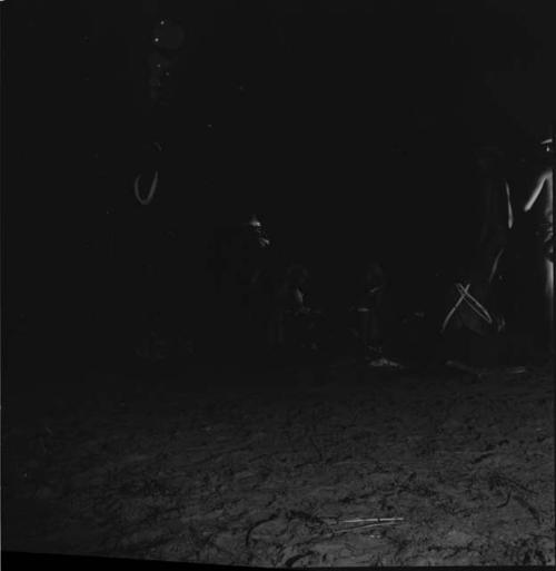 People dancing near a group of women sitting in a night dance