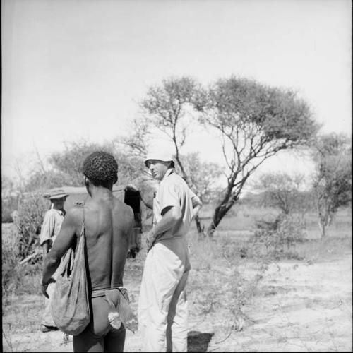 Man standing with two expedition members, with an expedition truck in the background