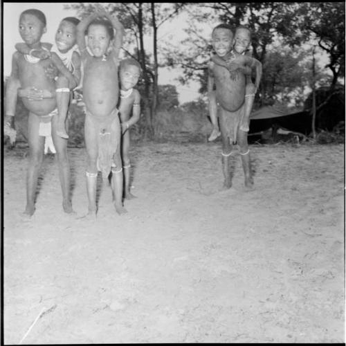 Group of children playing piggy-back