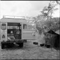 Luggage inside the expedition Land Rover, with a shelter next to it, equipment on the ground