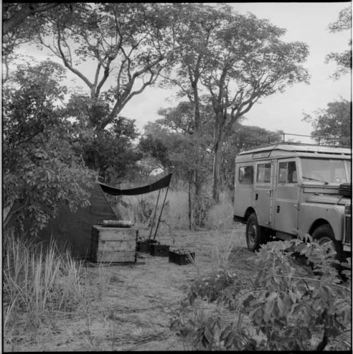 Expedition Land Rover, with a shelter next to it, equipment on the ground