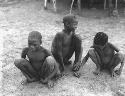 Unidentified boy, "≠Gao Lame" and Tsamgao squatting