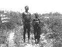 Tsamgao standing with his wife, Bau