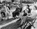 Group of people sitting, including P. Cardoss Grant and his wife, and Chief Sechele