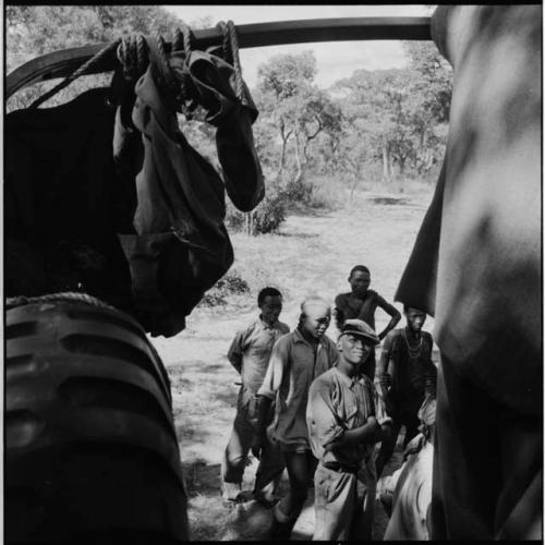 Group of men standing next to an expedition truck