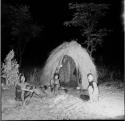 Three men sitting in front of a skerm at night