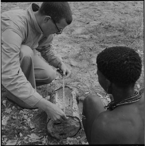 //Ao making a //guashi, with Nicholas England measuring the length of the log