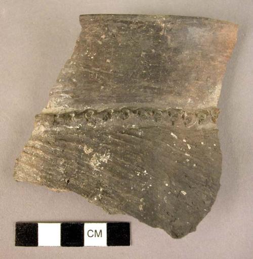 Fragment of pottery storage jar - plastique band at base of rim with irregular p