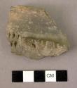 Fragment of pottery storage jar with double row of vertical cuts at base of rim-