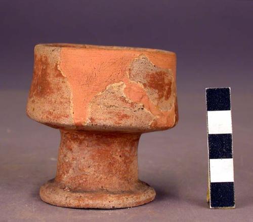 Small red pottery pedestal cup