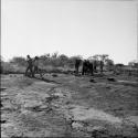 Group of people walking to a pan to wash clothes