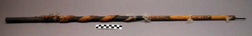 Cane whistle with tufts of down, reed, & plant fiber attached