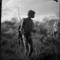 "/Gao Medicine" holding a stick, dancing in a daytime dance, with another man behind him