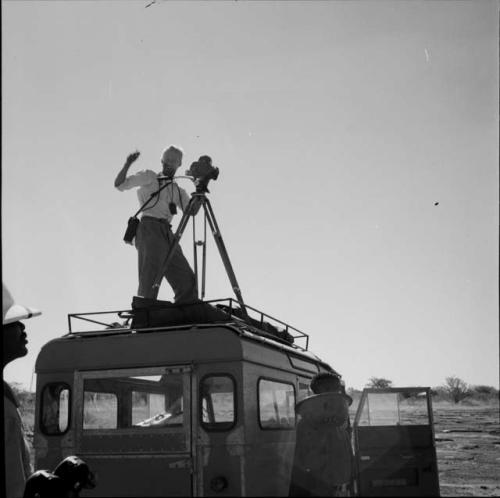 John Marshall filming from the top of the expedition Land Rover