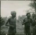 /Ti!kay, an unidentified man and Tsamgao playing the "hitting game"