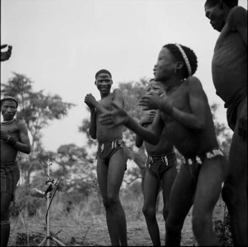 Boys playing the "hitting game," standing and clapping