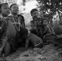 Two women sitting with three children