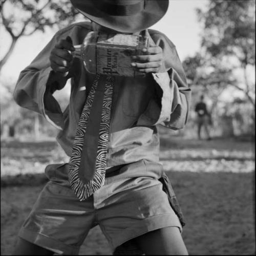 Tsamgao holding a brandy bottle, looking through it