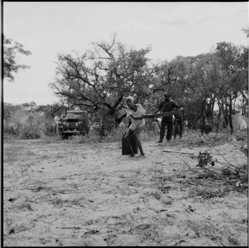 Tsamgao swinging a baseball bat, playing baseball with expedition members