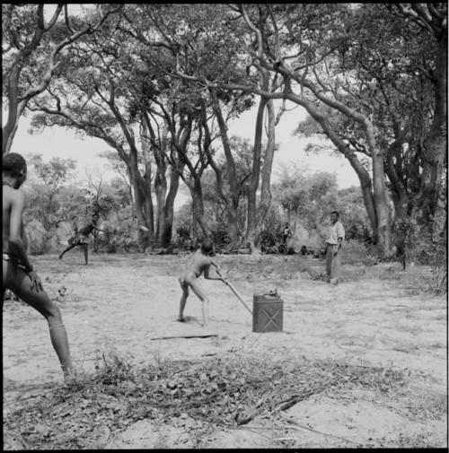 Boy preparing to bat a ball, playing baseball with expedition members