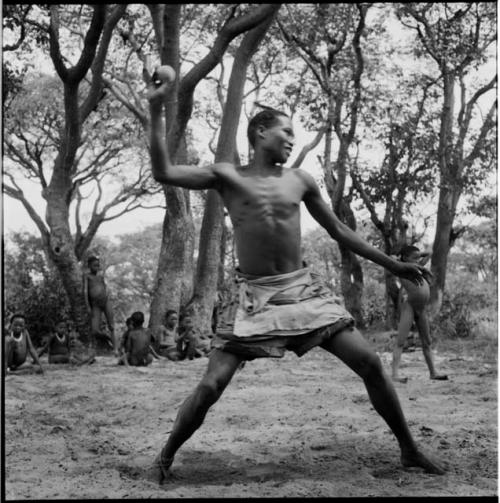 Man pitching a ball, playing baseball with expedition members