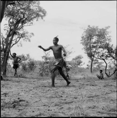 Man pitching a ball, playing baseball with expedition members