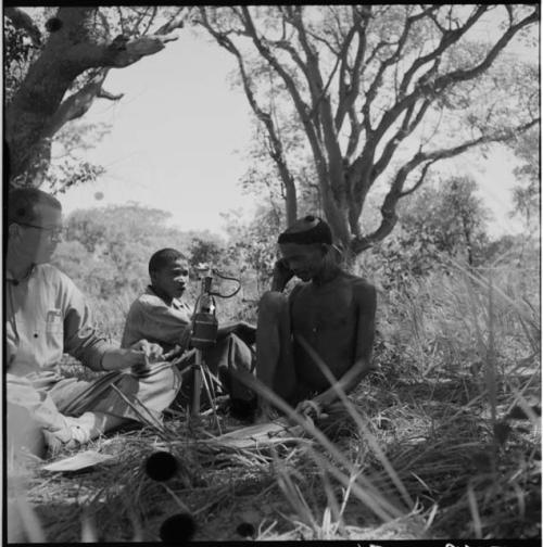 "/Gao Music" playing the //guashi, with Nicholas England recording him, another man talking in the background