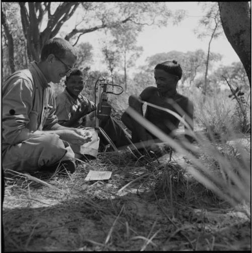 "/Gao Music" playing the //guashi, with Nicholas England recording him, another man talking in the background