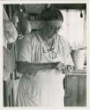 Woman working on a small pottery object