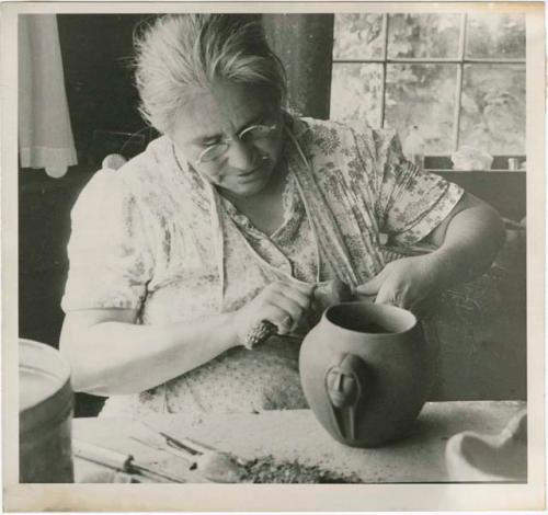 Maude Welch working on a pottery vessel