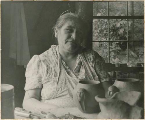 Maude Welch with pottery vessels