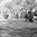 Group of people sitting, with a camera tripod next to them