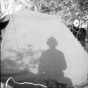 Cameraman's shadow on the side of an expedition tent