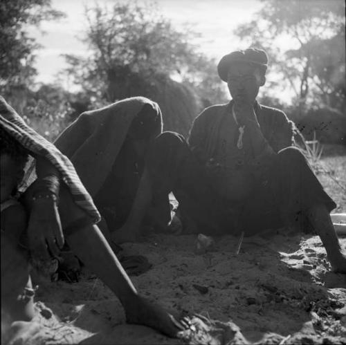 Man wearing a Western clothes, sitting and holding a pipe