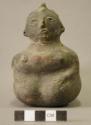 Ceramic effigy vessel, kneeling human figure, mended at neck, perforated through