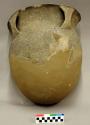 Ceramic, earthenware partial vessel, two handles, flared rim incised above handles, punctate shoulder, undecorated body, shell-tempered; reconstructed and crossmended with plaster, glue, or putty
