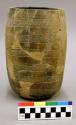 Ceramic, earthenware complete vessel, reconstructed, incised and rocker-dentate body, burnished, cylindrical form