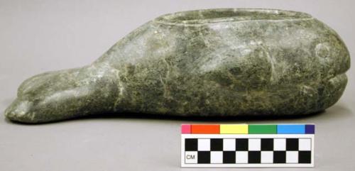 Stone effigy vessel, fish or whale, bowl carved into dorsal surface.