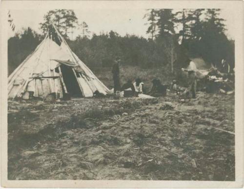 Clyde Williams and guide at Chippewa camp watching men play poker