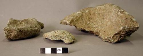 Ground stone fragments, some with handles