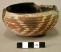 Ceramic vessel, coiled  bowl, red and white painted design, black interior, brok