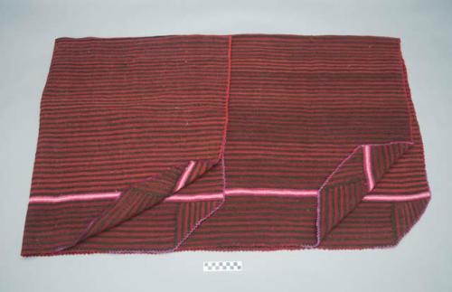 Man's poncho; red, black and pink