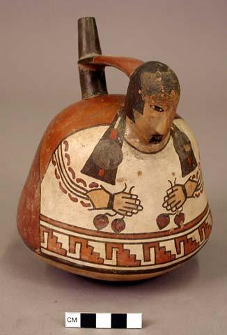 Female human effigy bottle, holding fruits in hands