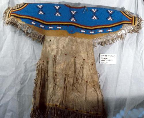 Girl's skin dress with beaded yoke and sleeves.