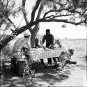 Expedition members sitting at a table covered with a checkered table cloth