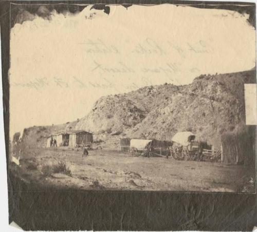 Covered wagons and buildings at the Point of Rocks station