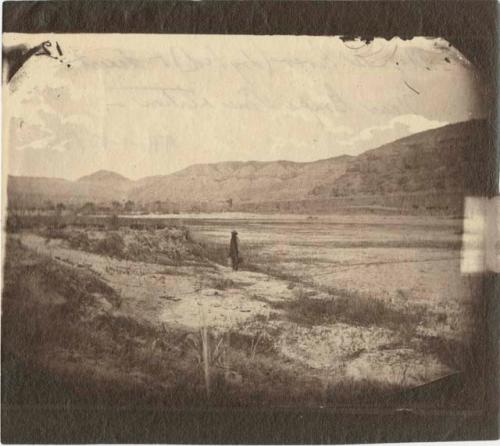 Person standing by the dry bed of the Mojave River