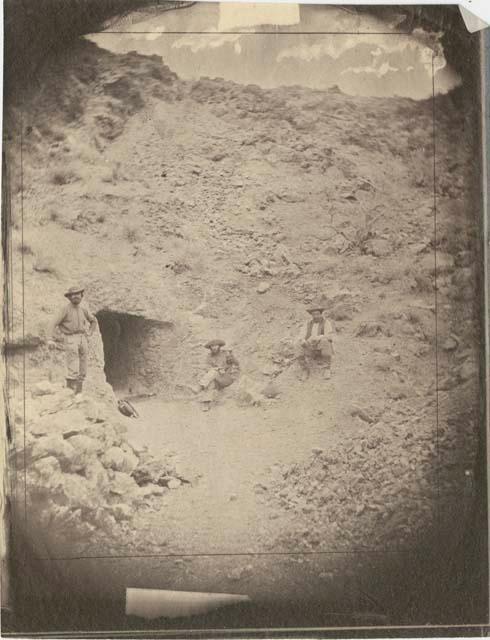 Men next to a mine entrance