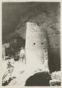 Man standing next to the Round Tower at Cliff Palace