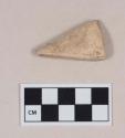 Cut and worked triangular shell fragment